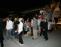 [Minister Peter MacKay, Prime Minister Stephen Harper and his wife Laureen Harper greet Canadians evacuated from Lebanon at the bottom of the stairs after arriving in Ottawa] 21 July 2006