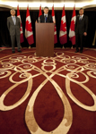 [Prime Minister Stephen Harper is joined by Lawrence Cannon, Minister of Foreign Affairs, and Gary Doer, Canada's Ambassador to the United States, as he announces a nuclear cooperation agreement with the United States in Washington, DC] 12 April 2010
