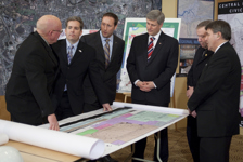 [Prime Minister Stephen Harper is joined by Bob Taylor, Mayor of the Municipality of the County of Colchester, Scott Armstrong, Peter MacKay, Darrel Dexter, Premier of Nova Scotia, and Bill Mills, Mayor of Truro, as he surveys building plans for the Central Nova Scotia Civic Centre in Truro, Nova Scotia] 21 January 2010