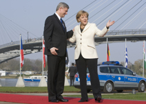 [German Chancellor Angela Merkel greets Prime Minister Stephen Harper prior to a NATO military ceremony and family photo in Strasbourg, France] 4 April 2009