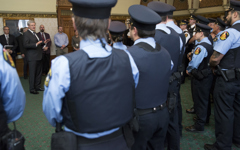 [Prime Minister Stephen Harper meets with members of the House of Commons and Senate security teams the day after the attack on Parliament Hill] 23 October 2014