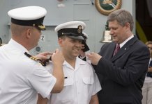 [Prime Minister Stephen Harper awards young sailors with new ranks on the deck of the Canadian naval frigate HMCS Fredericton during his visit to Bridgetown, Barbados] 19 July 2007