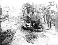 Binding a wounded Canadian. Sept. 1916 Sept., 1916.