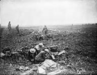Canadian machine gunners dig themselves in, in shell holes on Vimy Ridge April, 1917.