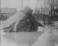 A Canadian finds his tent and home under water. Apri1, 1917.