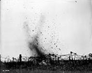 Breaking up barbed wire with trench mortar shells. May 1917 MAY 1917