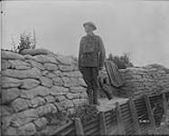 A Canadian sentry watching result of our artillery fire. July, 1917 July, 1917.