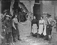 Damage caused by stray Boche shell. French women congratulate 15th Battalion on their escape Aug., 1917.