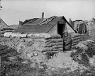 Outside his little "Grey Home" on the Western Front. (Canadian Railway Troops) September, 1917 Sep., 1917.
