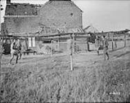 General Odlum and Staff playing badminton in a village near Lens. August, 1917 Aug., 1917.