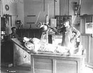 A bullet in the arm of a french soldier being X-rayed in No. 8 General Hospital, St. Cloud, Paris. October, 1917 Oct., 1917.