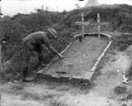 Canadian soldier tending graves of fallen French comrades. September, 1917 Sep., 1917.