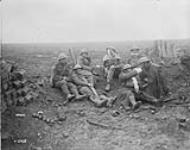 Wounded Canadians rest near Heine pill-box. Battle of Passchendaele. November, 1917 Nov., 1917.