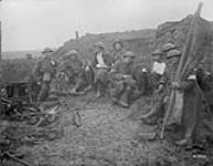 Wounded Canadians taking cover behind pill-box. Battle of Passchendaele. November, 1917 Nov., 1917.