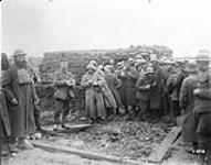 Hot tea and biscuits being given to Boche prisoners, presumably taken during the Battle of Passchendaele Nov. 1917