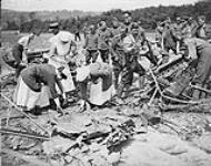 Canadian Nurses viewing the remains of a Gotha which was brought down in flames near their Hospital, 1918/06 June, 1918.