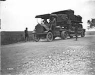A French Caterpillar on a lorry passing through the Canadian Lines. Amiens. August, 1918 Aug., 1918.