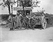 Canadian and French officers taking cover behind a German ammunition wagon. Battle of Amiens. August, 1918 Aug., 1918.