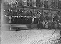 President Poncaire addressing the deputy Mayors of Valenciennes, General Horne and General Watson, from the steps of the Hotel de Ville on Nov. 10th, 1918 November 1918.