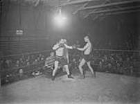 (Boxing) View at the Boxing Championship for Canadians in England, held at Shorncliffe, 1918. Featherweight final: - Pte. J. McCracken (Winner, and Driver C. Smith.) 1914-1919