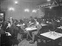 Groups in large dining room at the Little Theatre. Canadian Y.M.C.A 1914-1919