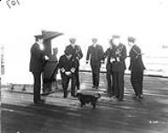 Vice-Admiral Sir Charles Madden, K.C.B. with his staff and Mascot on board his Flagship Feb., 1917.
