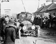 Motor car passing through a village in France (presumably a "Staff Car") 1914-1919