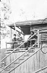 A family on their porch [1898-99] [between 1898-1899].