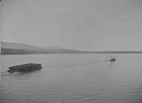 Tug & load along Pacific Coast near Alert Bay, B.C. Sept. 1937