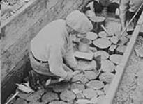 Large flumes & sluices: - Close-up of method of placing wood blocks into flume, Lowhee Creek, B.C 1938