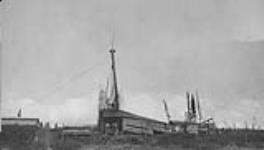 Discovery well shooting oil, Mackenzie District, N.W.T Aug. 1923