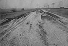 Low cost road construction in Manitoba. Road surface before application of base coat. 1930