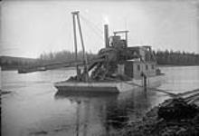 Dredge operating on Stewart River, Y.T