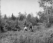 Combined Geophysical Methods Inc.-Laying down and connecting wires. Adjusting the comparator. Porcupine, Ont 1936