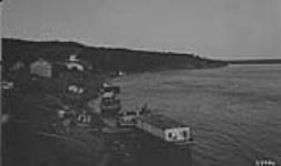 General view of the waterfront at Fort Smith N.W.T. Houseboat "H.B.C." in foreground and S.S. "Distributor" in distance n.d.