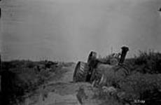 Tractor stuck in road fill across a slough, Sask. 23-13-2 Sec. 12 [about 7 mi. E. of Lipton, Sask.] 1923