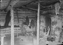 Interior of shack built around fireplace at Fort Reliance by "Buffalo Jones" N.W.T 1900