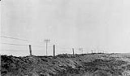 Soil drifted along fence and telephone line [Sask.] 1920