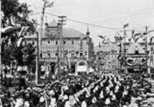 (Quebec Tercentenary) Troops passing Place d'Armes 1908