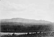 Canadian Pacific Railway Survey. From hill behind Babine village looking west. Suskwa Summit and Pass in the distance/Levés du Canadien Pacifique. À partir du même endroit que le 16 colline située derrière le vilage de Babine, direction ouest Aug. 1879
