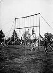 (Track & Field) Climbing the ropes in the Obstacle Race. Empire Day Canadian Athletic Meeting at Godalming 1914-1919