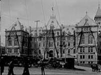 [City Hall Quebec, P.Q. with flag at half-mast and draped, mourning the death of Cardinal Taschereau] [1898]
