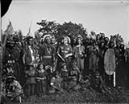 Group of First Nations actors during the Tercentenary celebrations in Quebec City, Quebec, 1908. [The man third from the left, wearing a necklace, has been identified as possibly Thomas "Thanenrishon" Williams, a Mohawk man from Kahnawà:ke (Kahnawake).] 1908