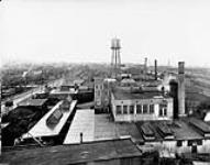 Plant No. 1 - 4.7" roughing shop in foreground, 6" shop beyond water tower. P. Lyall & Sons Construction Co. Ltd., Montreal, P.Q [1914-1918]