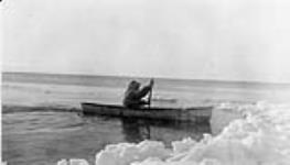 Blue Fox Harbour, N.W.T. Fred Carpenter in open-water canoe made of bearded seal skin Winter 1932-33