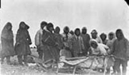 Egg River, Banks Island, N.W.T. The first meeting of the Western Eskimos and the Copper Eskimos on Banks Island. The Western Eskimos are dressed in skins, while the Copper Eskimos are in duffle and stroud Spring 1932