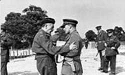General A.G.L. McNaughton, Canadian Corps, 1941. The tall officer on the right is Lord Duncannon, General McNaughton's a.d.c. and the Earl of Bessborough's son 1941