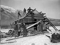 (Relief Projects - No. 23). Roofing a new sleeping hut Nov. 1935