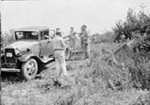 (Relief Projects - No. 27). Cutting a new road through the brush May 1934