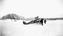 (Relief Projects - No. 51). Helping [de Havilland DH-83 Fox Moth] with skis frozen in slush ice Jan. 1935